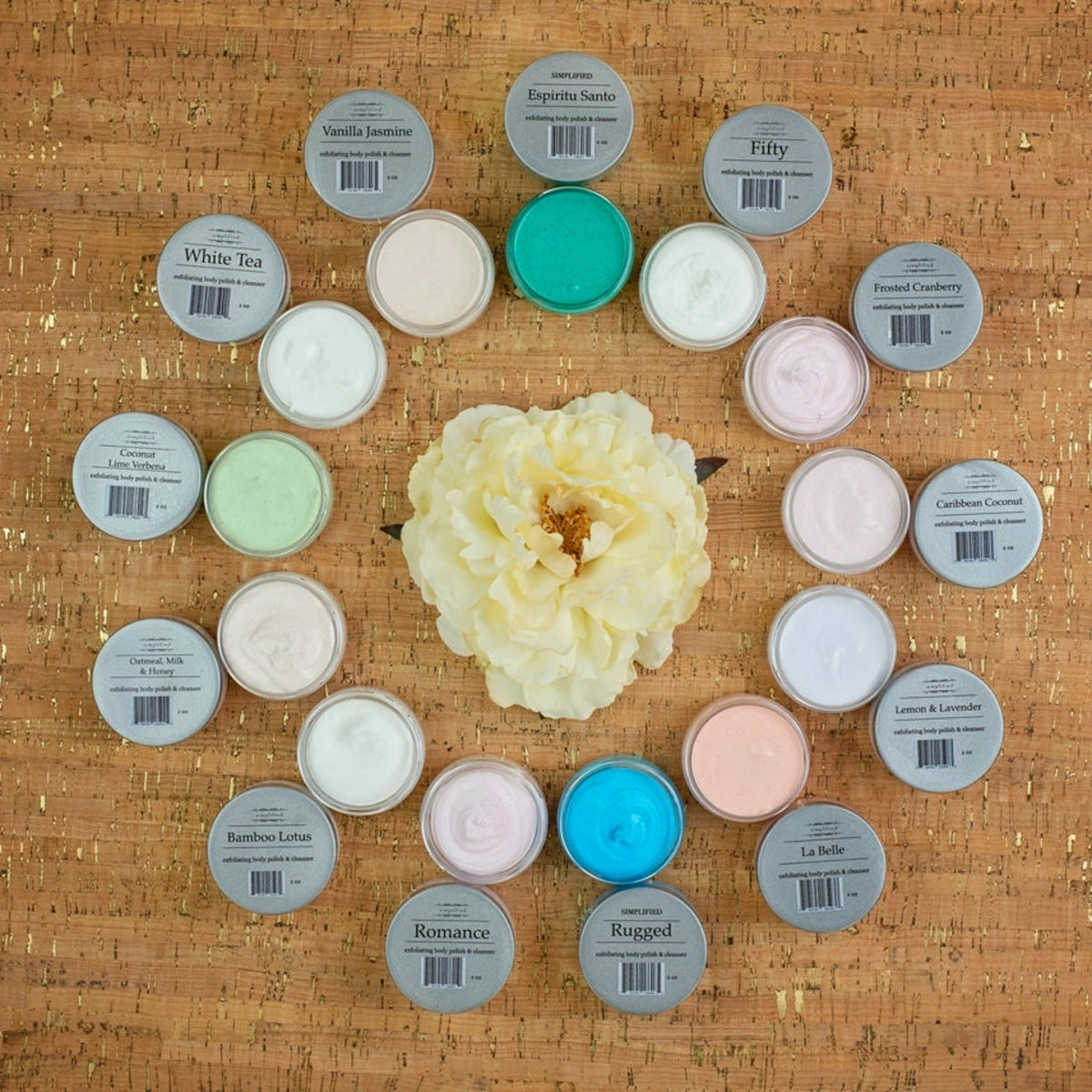 Travel-size exfoliating body polish and cleanser assortment of round tins with assorted lid colors