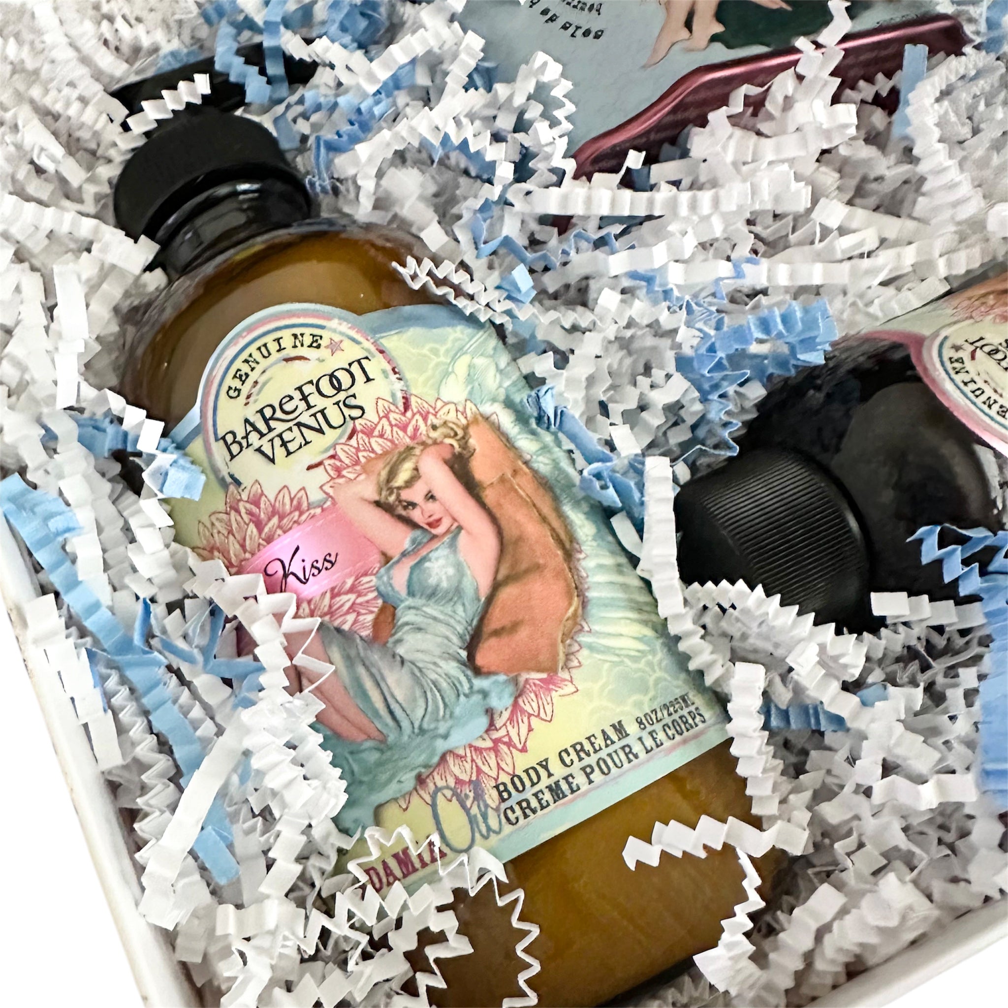Barefoot Venus body cream and lotion bottles in gift box with white and blue filler