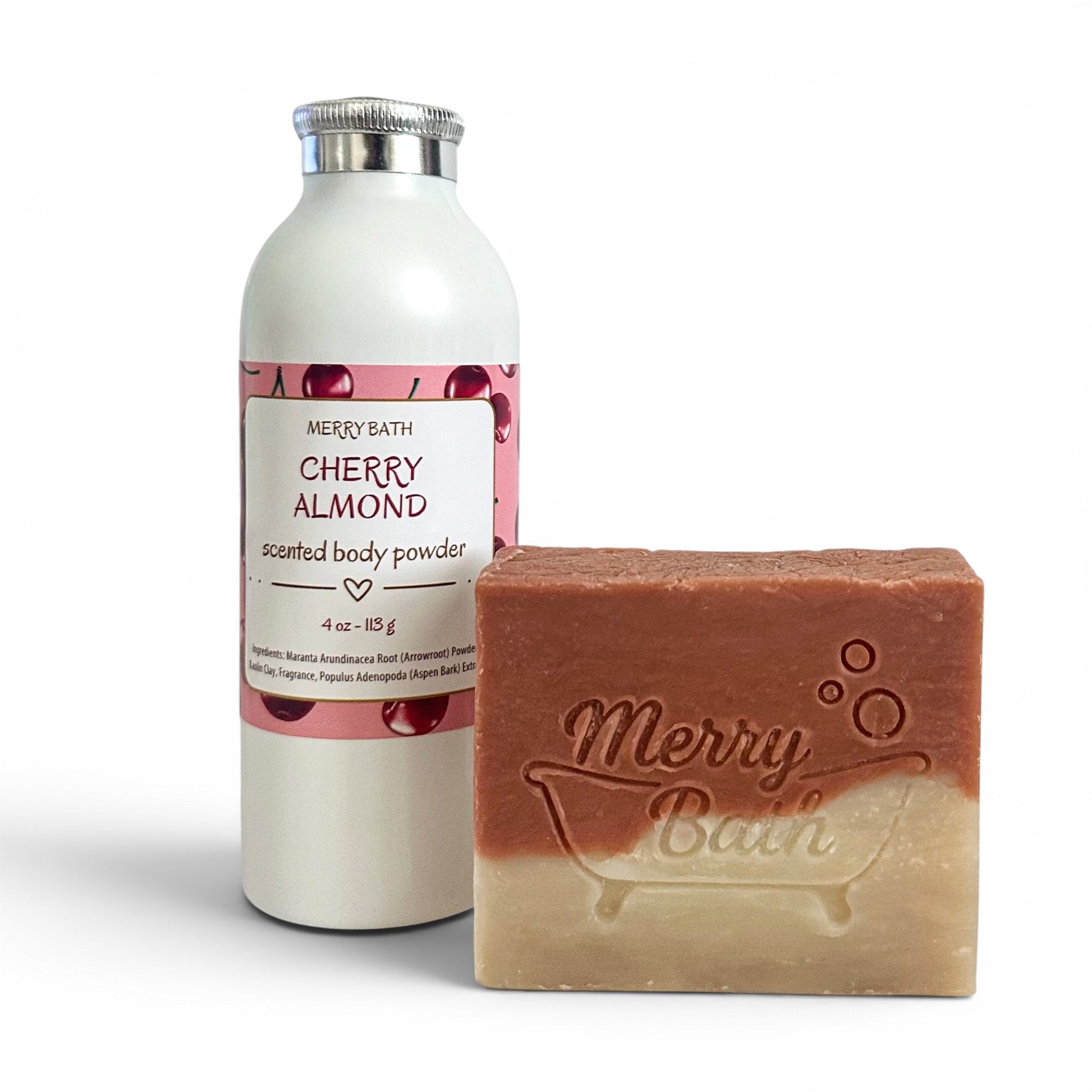 Bottle of cherry almond scented body powder and bar of soap with 'Merry Bath' branding on a white background.
