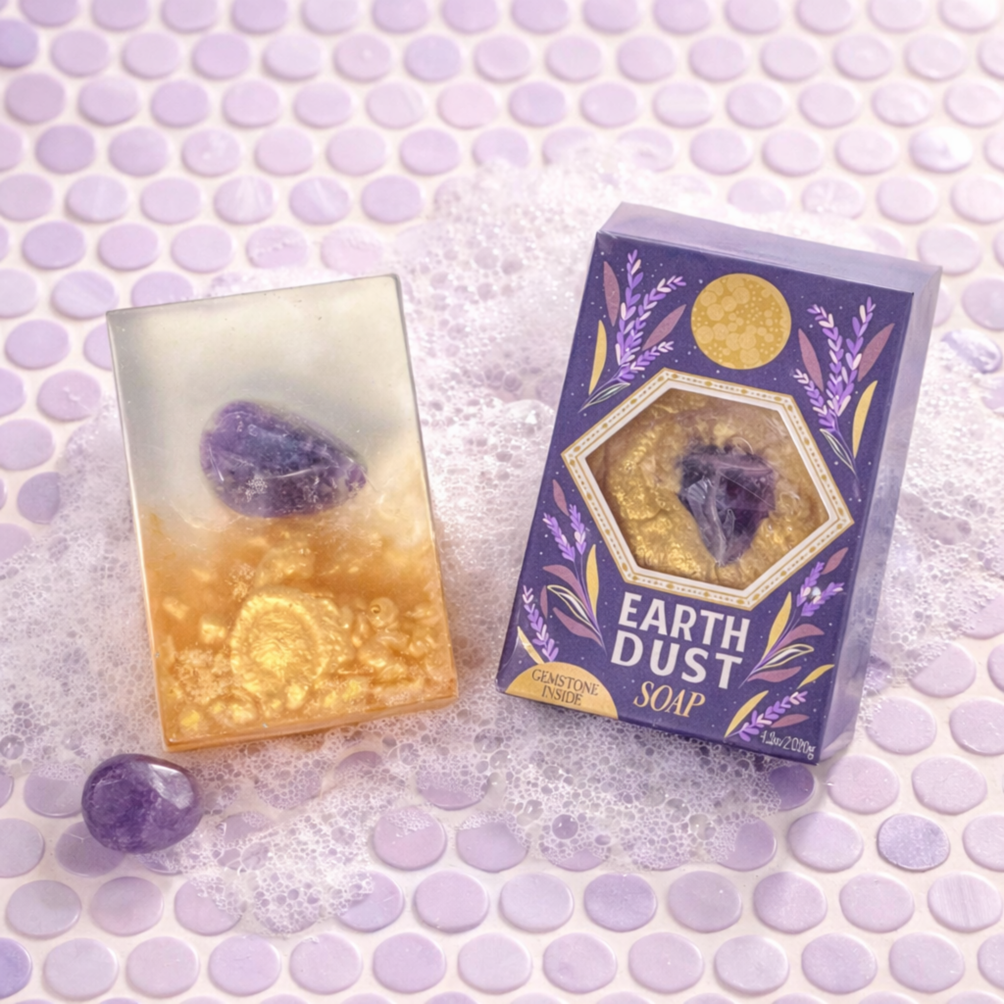 Earth Dust Soap packaging with a purple and gold design on a textured surface