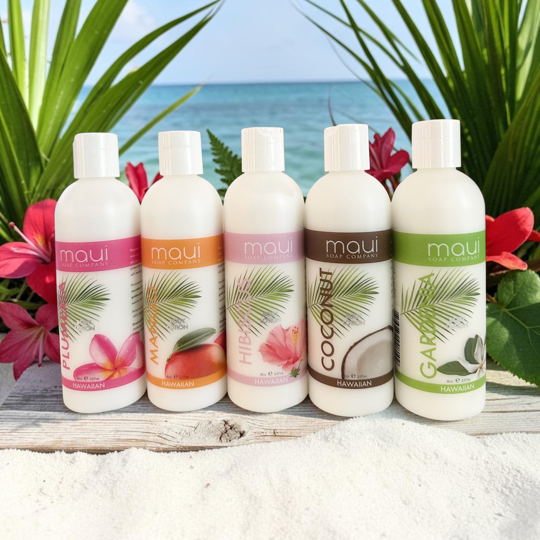Body lotion bottle set with white caps, labeled Maui Coconut and Hibiscus