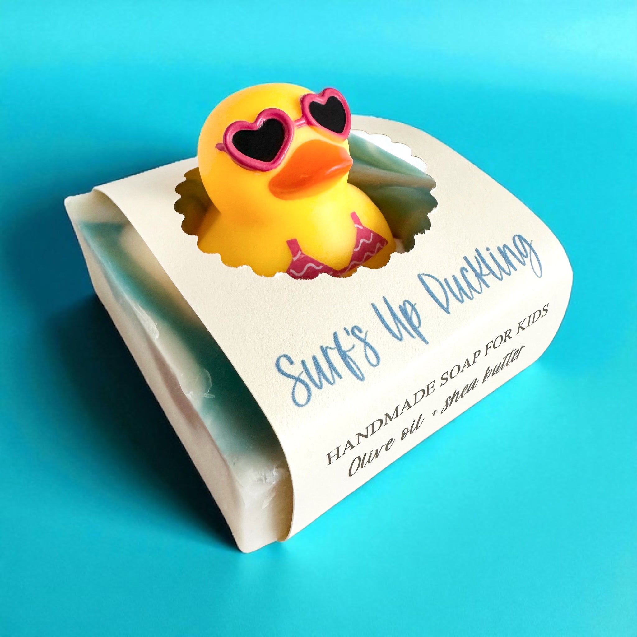 Kids handmade soap bar with yellow duckling design on labeled packaging.