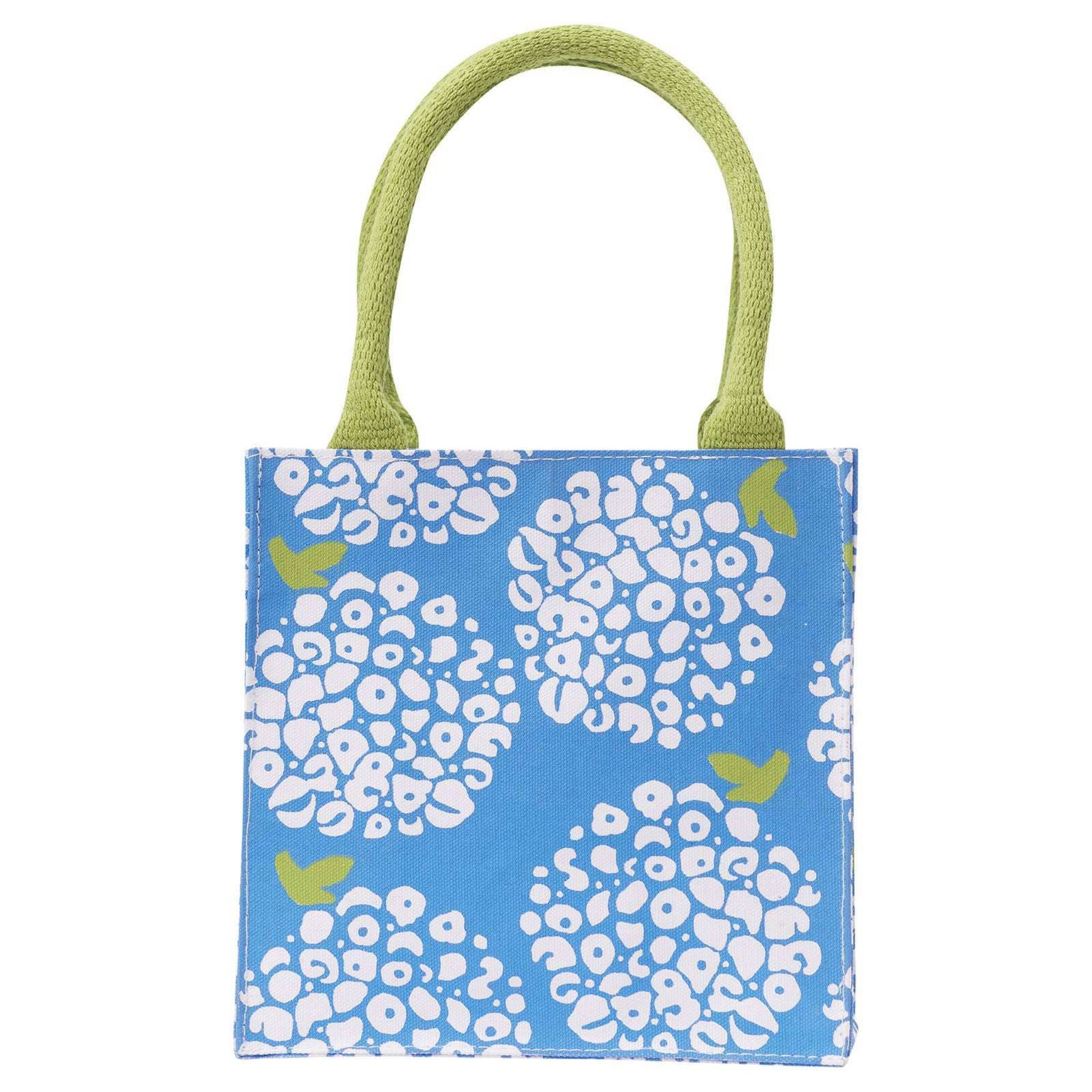 Small tote bag with floral pattern and green handles on a white background