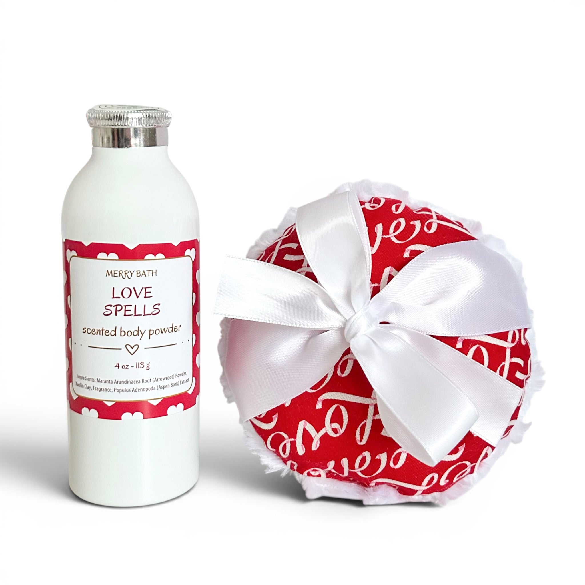 White bottle of 'Love Spells' scented body powder with a red and white patterned cover and bow on a white background.