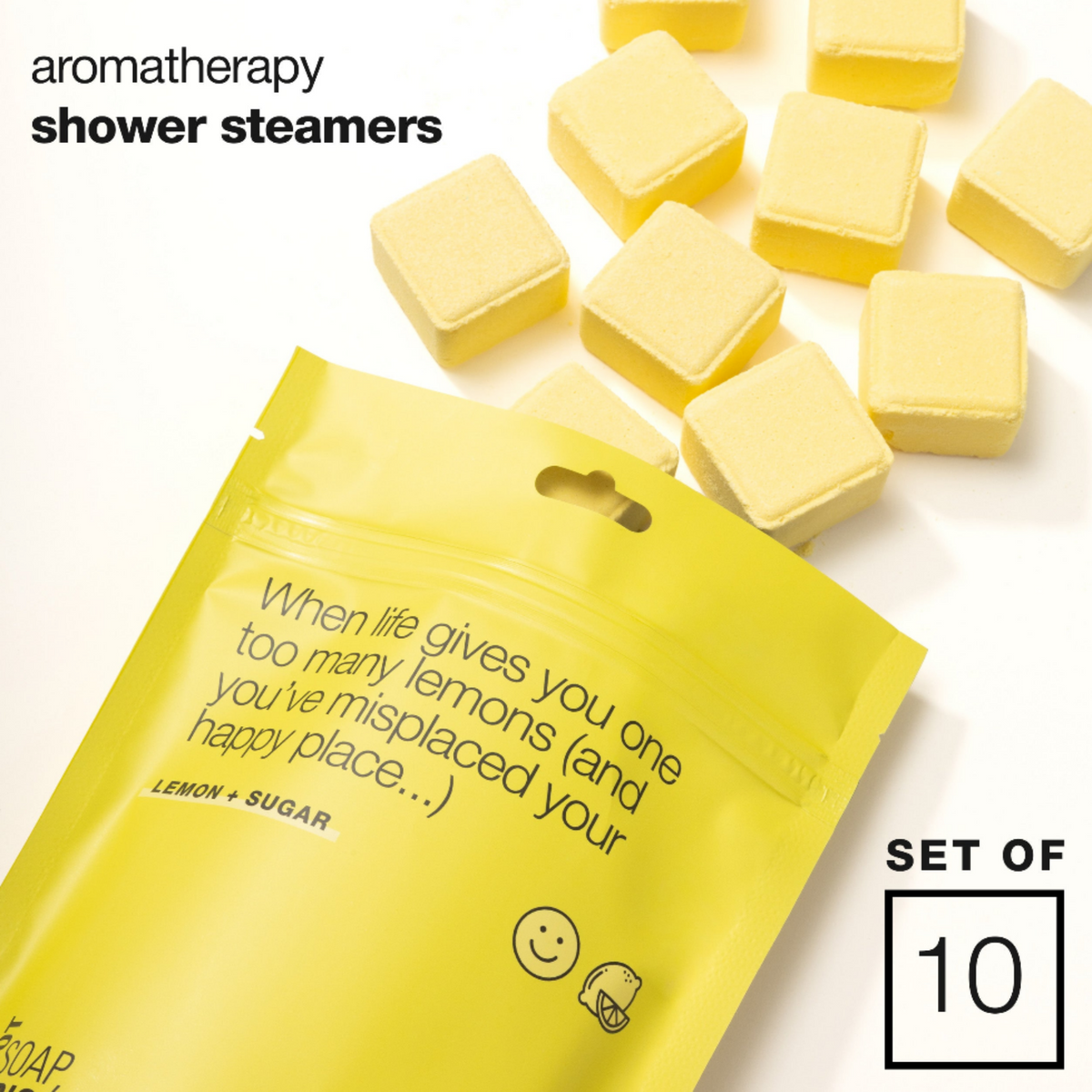 Yellow shower steamers scattered on a white background next to a bright yellow resealable pouch with printed text and a 'SET OF 10' badge.