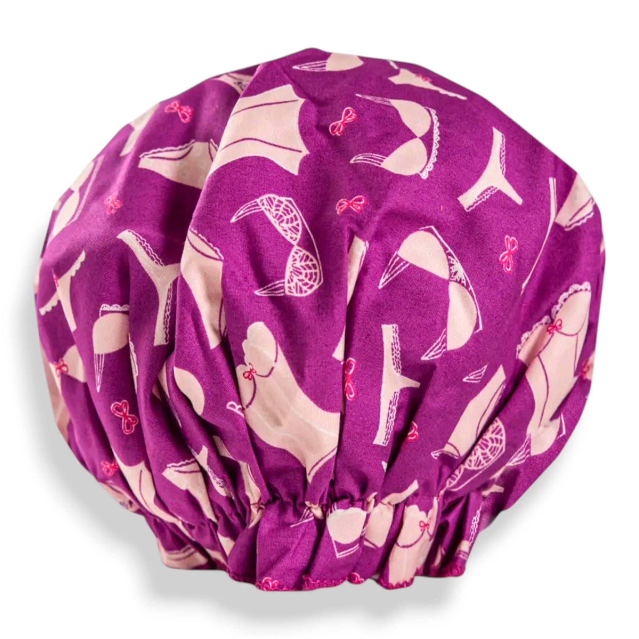 Bouffant shower cap, purple fabric with white whimsical character prints and gathered hem