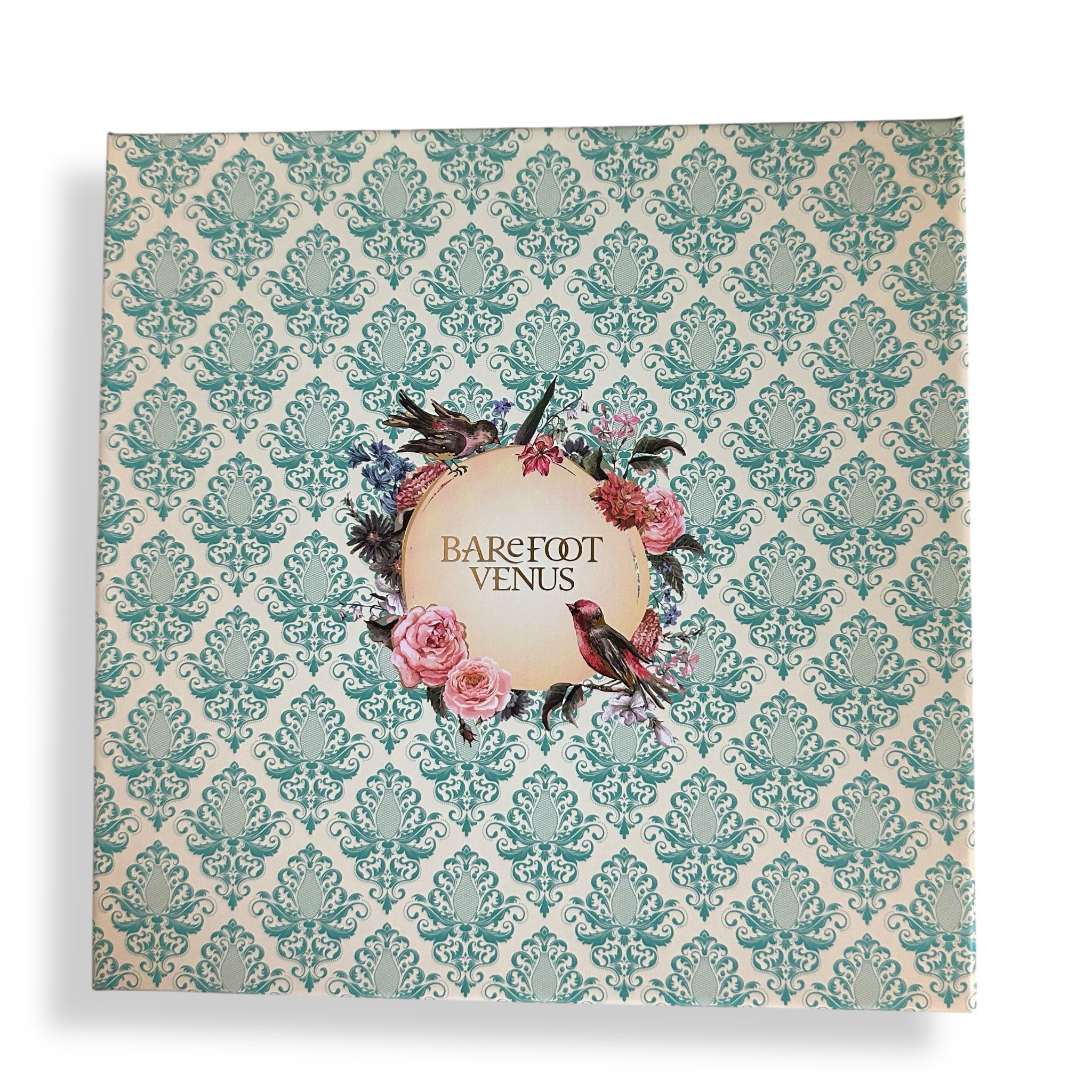 Decorative bath gift set lid with teal damask pattern and Barefoot Venus label