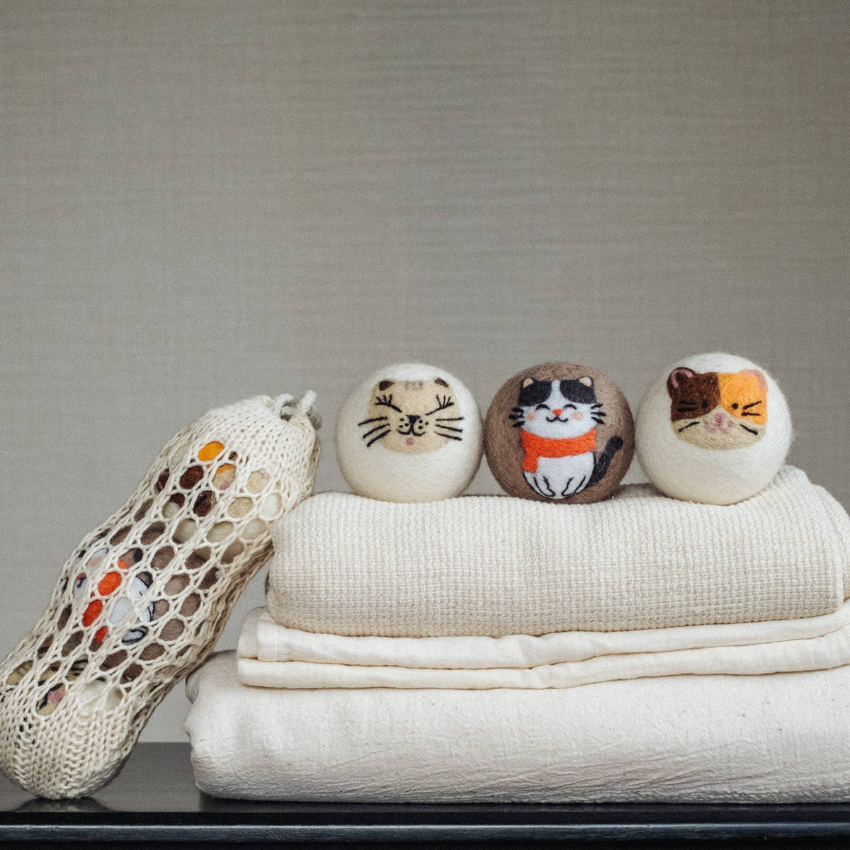 Natural wool dryer balls gift set of 3, cat-face dryer balls with mesh pouch draped over