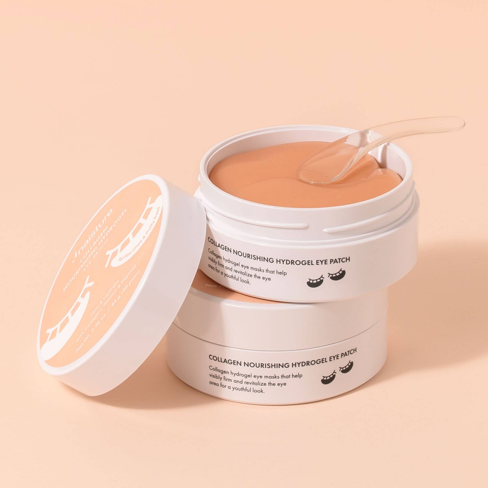 Jar of eye patches with a lid on a beige background