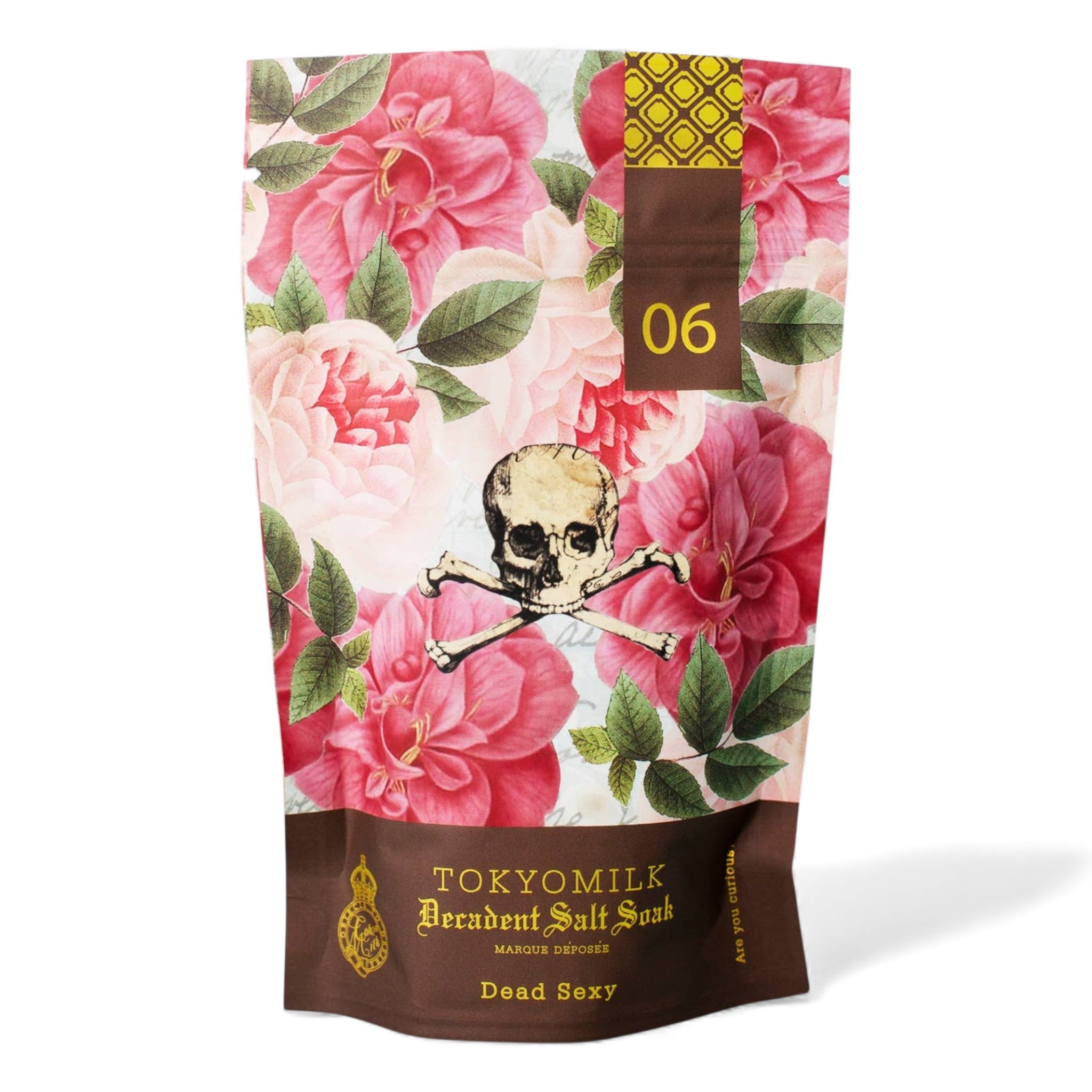 TOKYOMILK Dead Sexy salt scrub packaging with floral design and skull illustration.