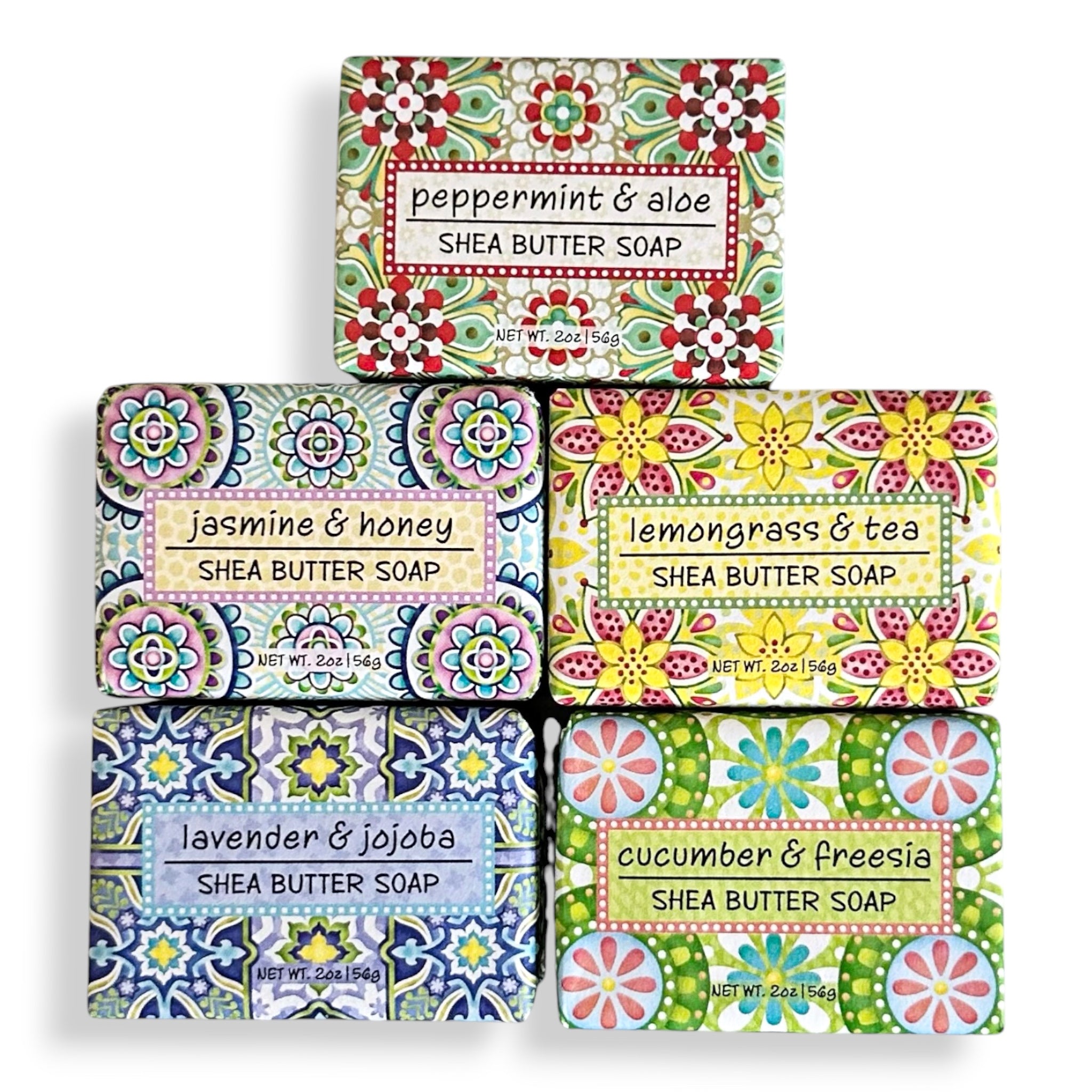 Six bars of patterned shea butter soap arranged in a 2x3 grid on a white background, with labels reading peppermint & aloe, jasmine & honey, lemongrass & tea, lavender & jojoba, cucumber & freesia, and a central blank bar.