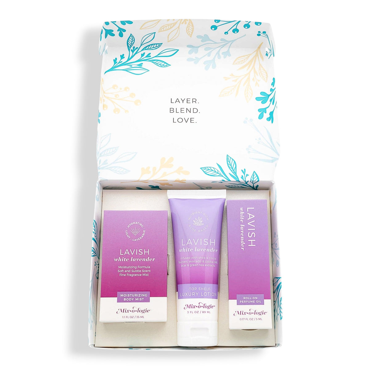 Lavish  gift set featuring three lavender-themed products inside a white box with teal and gold botanical illustrations. The set includes a white and purple shampoo, a purple conditioner, and a purple hair oil, all branded by Mixologie.