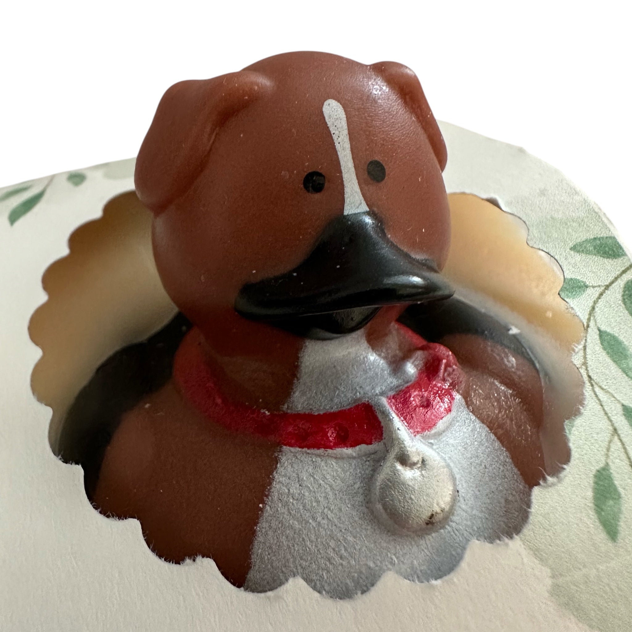 Handmade soap bar shaped like a brown dog with a red bandana and black nose.