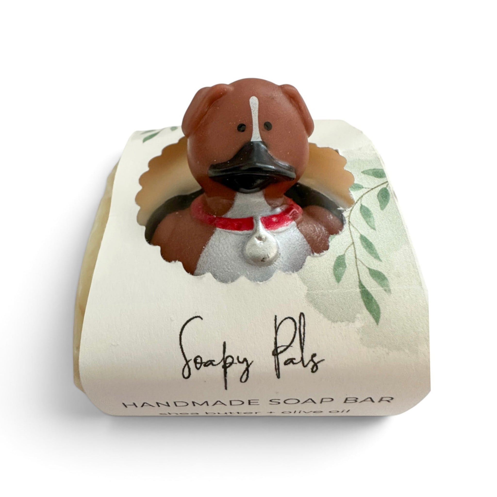 Handmade soap bar shaped like a brown dog wearing a red bandana and black nose.