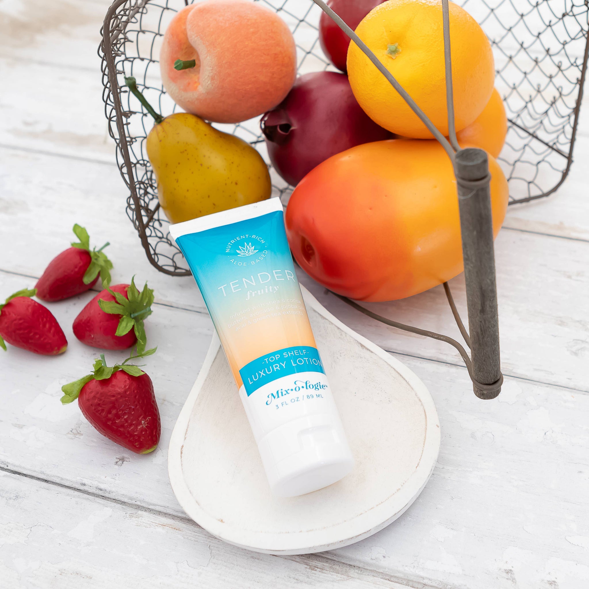 Tube of Tendresse body lotion with fruits and strawberries on a wooden surface