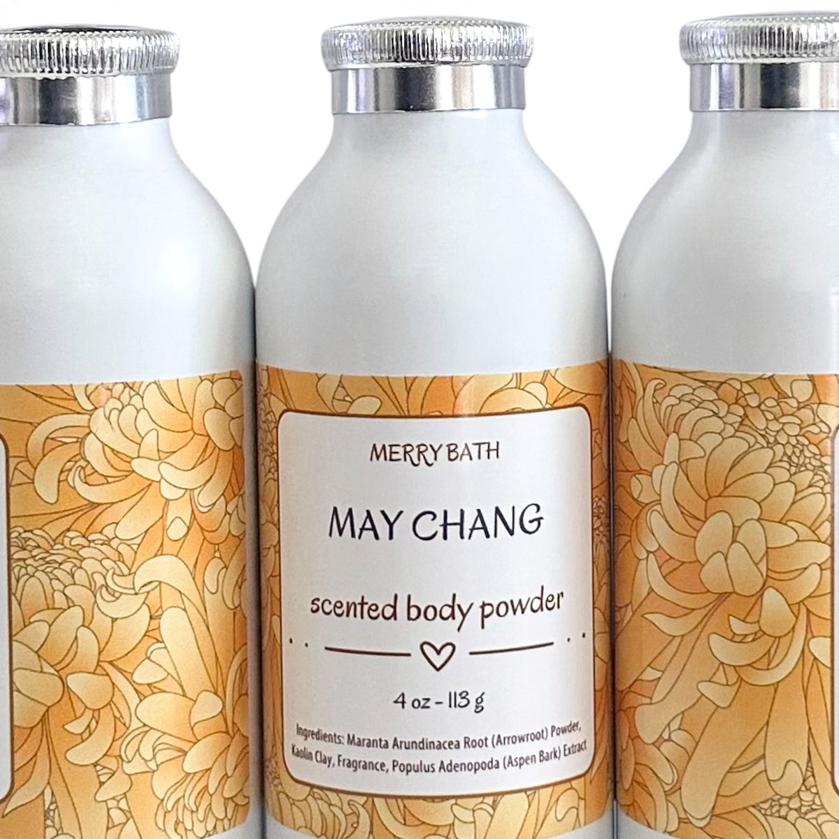 Three white cylindrical bottles of Merry Bath May Chang Scented Body Powder with gold floral labels and silver caps, shown against a white background.