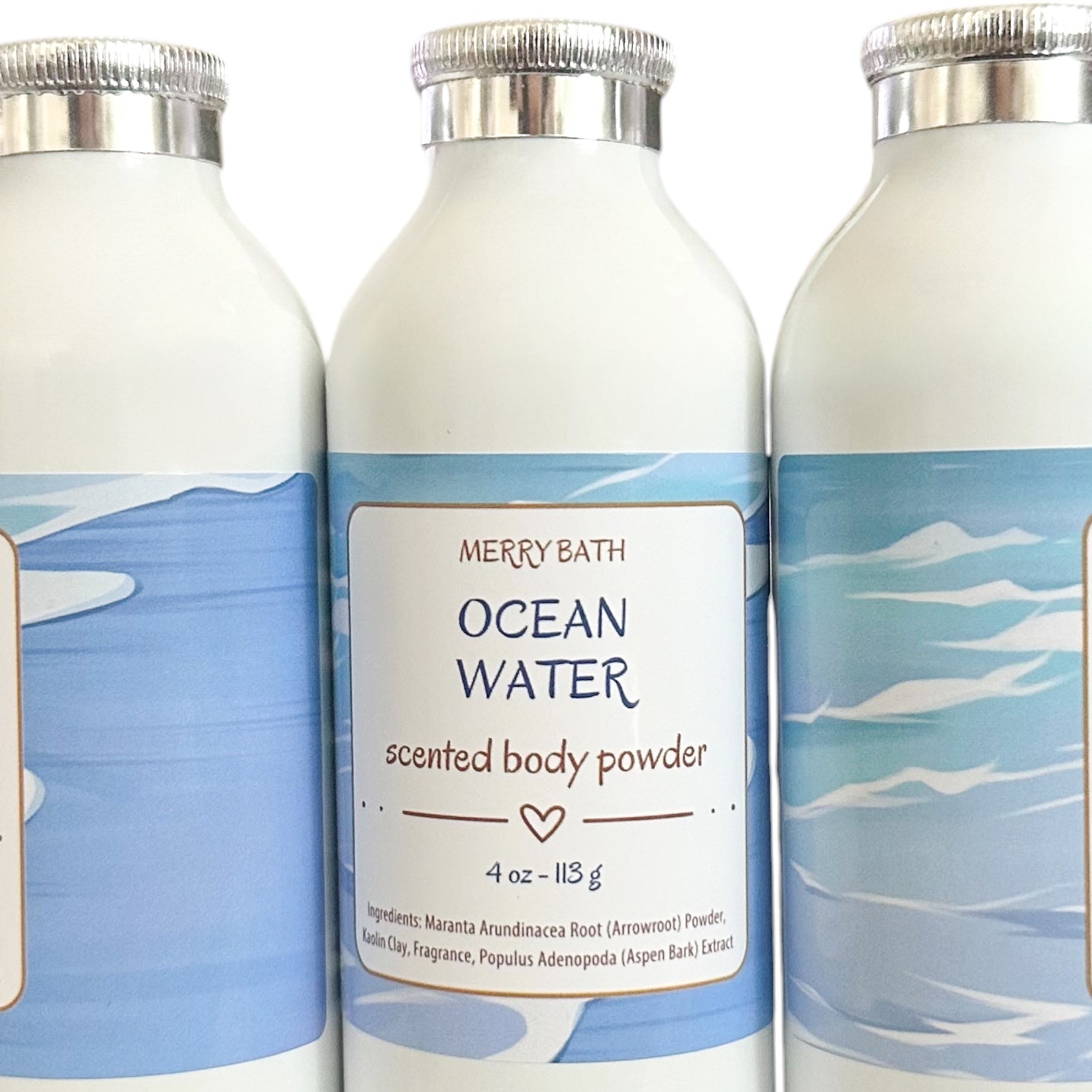 Three white bottles of Merry Bath Ocean Water Scented Body Powder with blue ocean-themed labels and silver caps, shown against a white background.