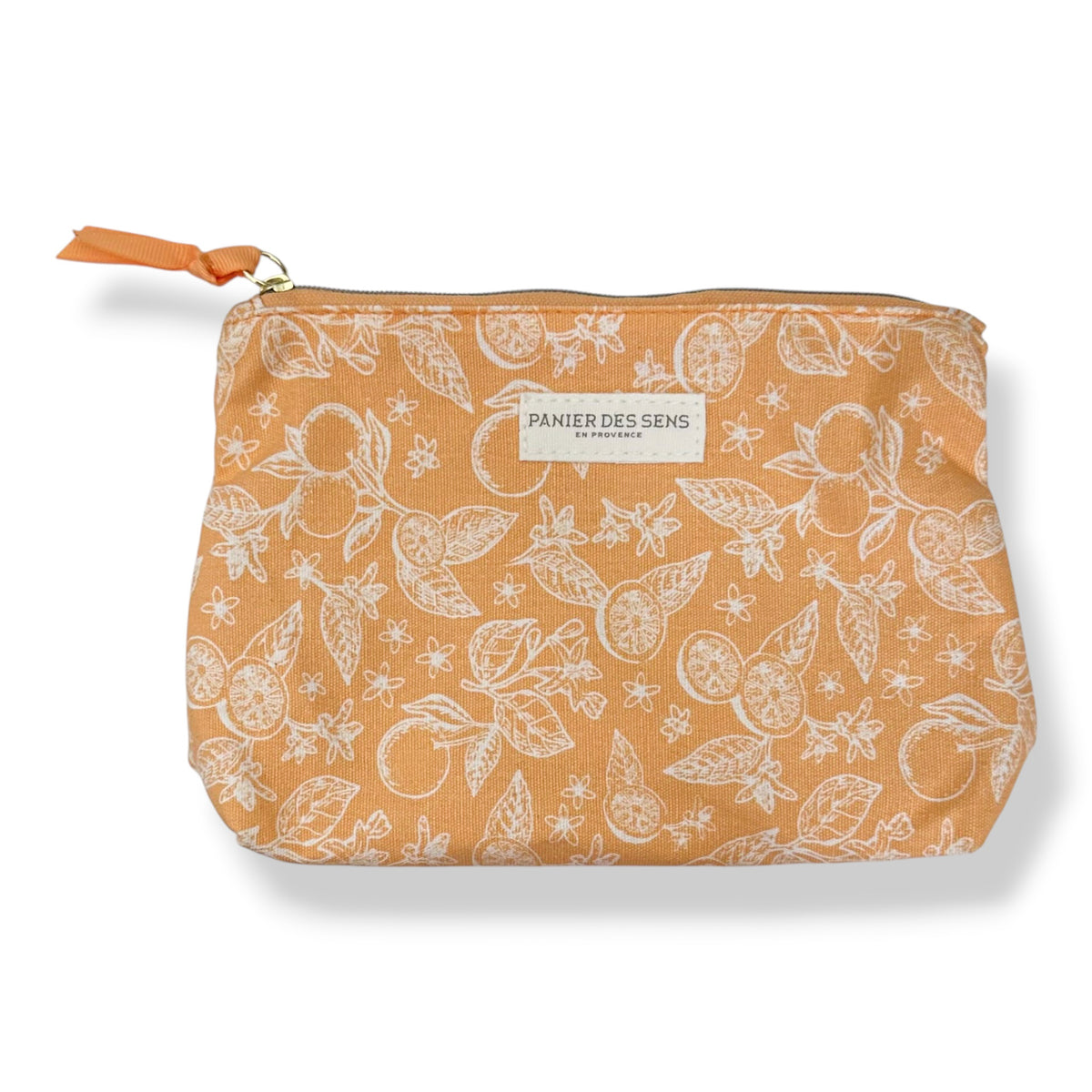 A rectangular zippered pouch by Panier Des Sens in a warm orange fabric with a white botanical pattern of oranges, leaves, and flowers. It features a matching orange fabric zipper pull and a white brand label on the front.