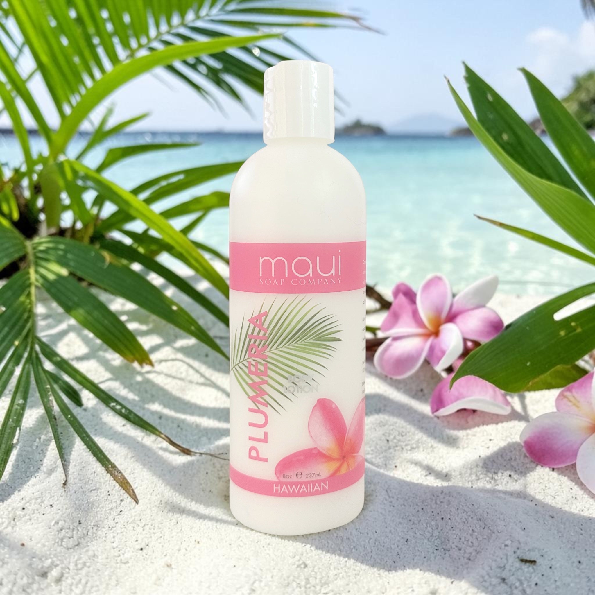 Body lotion bottle with white cap and pink PLUMERIA label, Maui