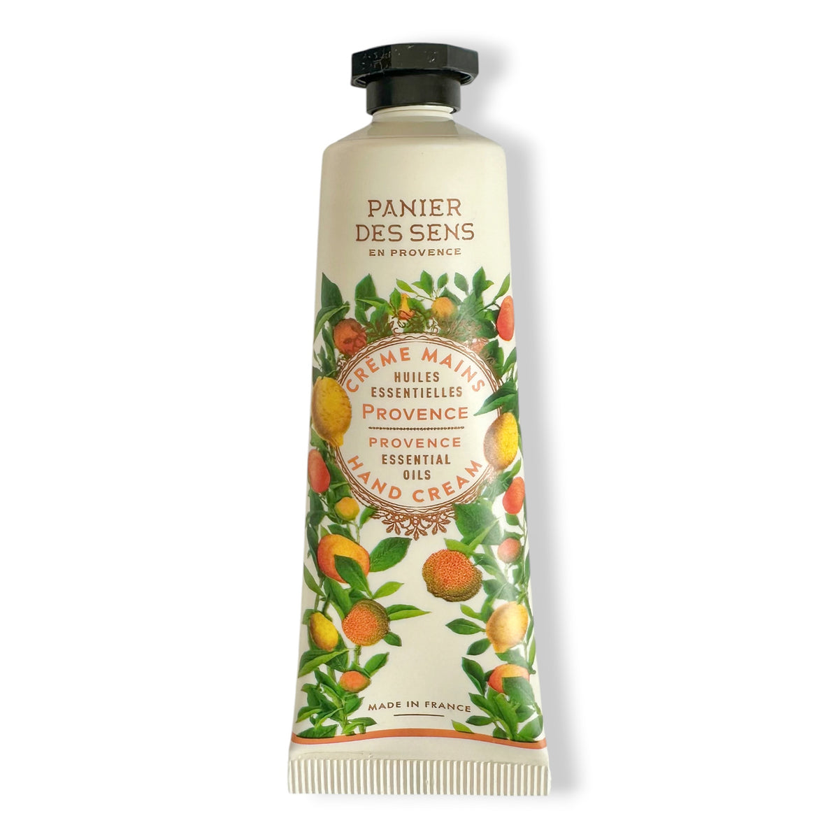 A squeeze tube of Panier Des Sens Provence Essential Oils Hand Cream, decorated with illustrations of oranges and green leaves on a white background.