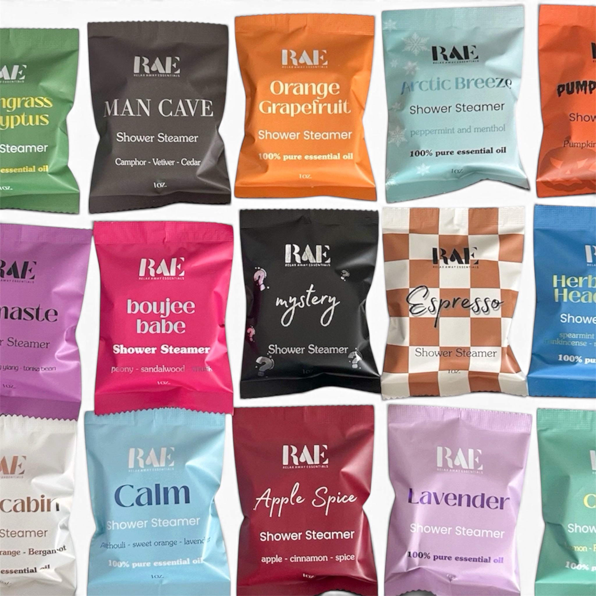 A grid of RAE brand shower steamer packets in assorted colors and scents, including Man Cave Grapefruit, Arctic Breeze, Calm, Apple Spice, and Lavender, arranged on a white background.