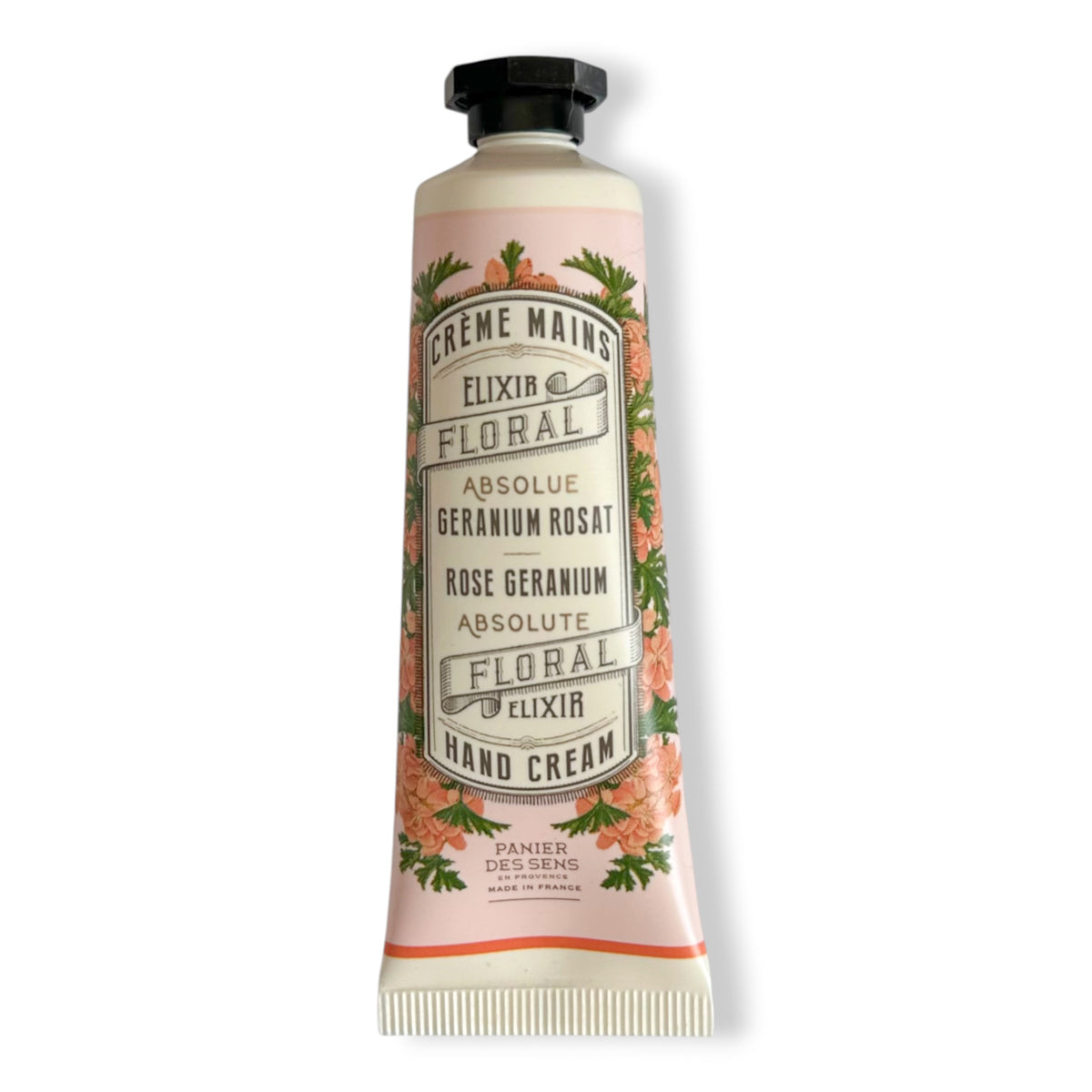 A squeeze tube of Panier Del Sens Elixir Floral Hand Cream, featuring a pale pink label with orange floral illustrations and a black cap, set against a plain white background.