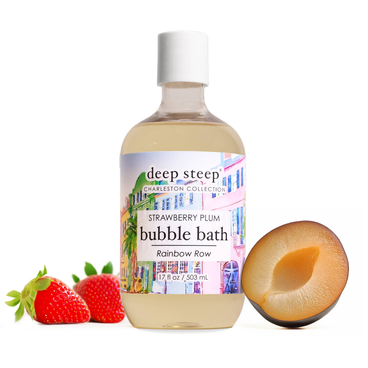 A bottle of deep steep Strawberry Plum bubble bath from the Rainbow Row Charleston Collection, styled with fresh whole and halved strawberries on a white background.