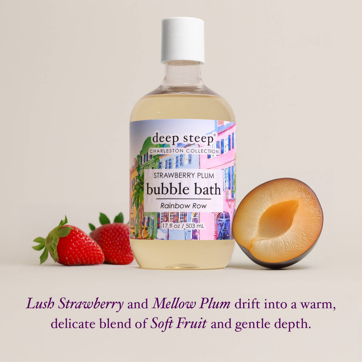 A bottle of Deep Steep Correctional Collection Strawberry Plum bubble bath is centered on a light beige background, flanked by fresh strawberries and a halved plum. Purple text at the bottom describes the scent as a blend of soft fruit and gentle depth.