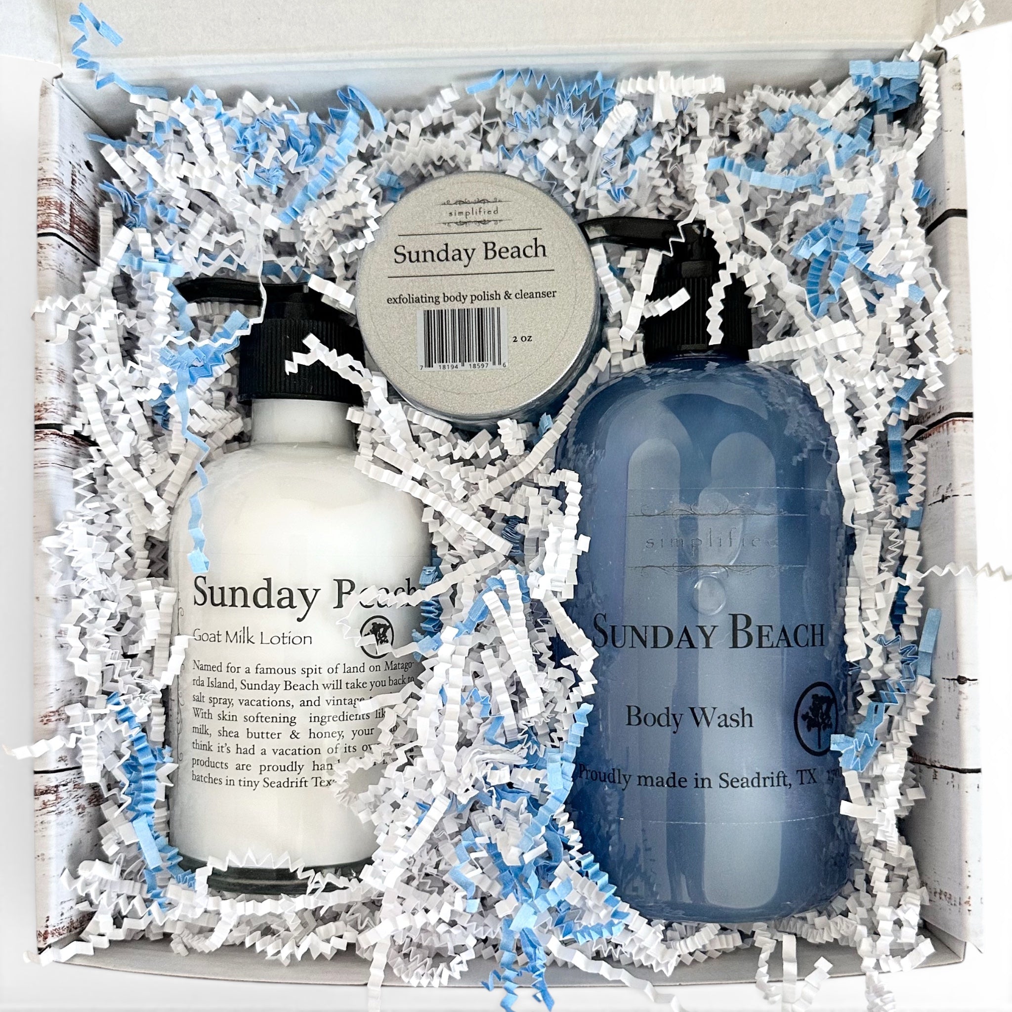 Sunday Beach body care products in a box with shredded paper