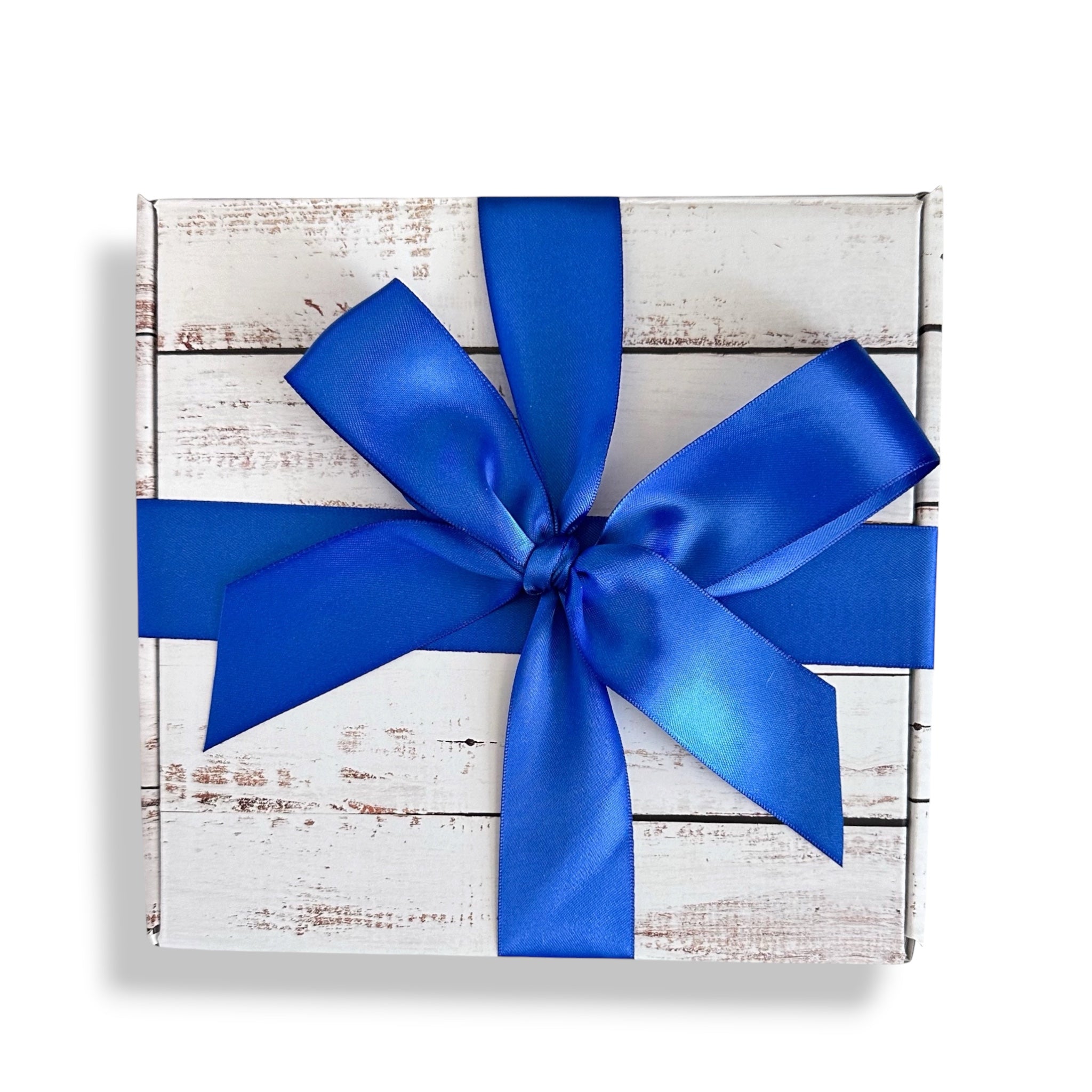 Gift box with a blue ribbon on a white wooden background