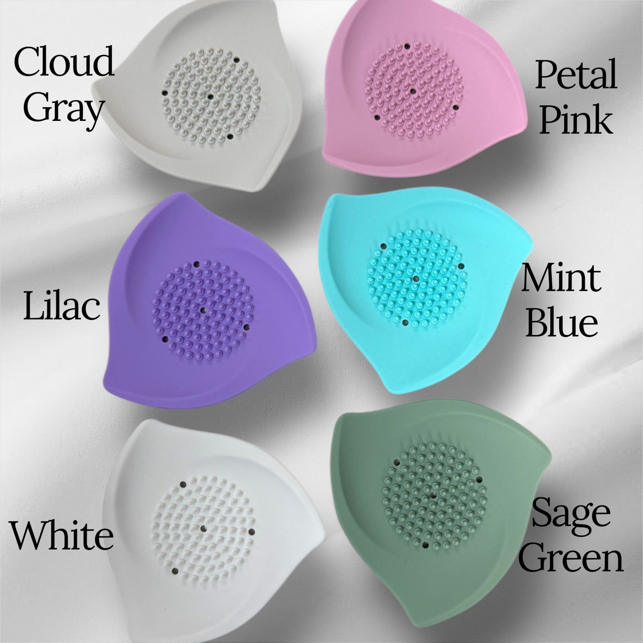 Assorted silicone shower steamer trays in cloud gray, petal pink, lilac, mint blue, white, and sage green