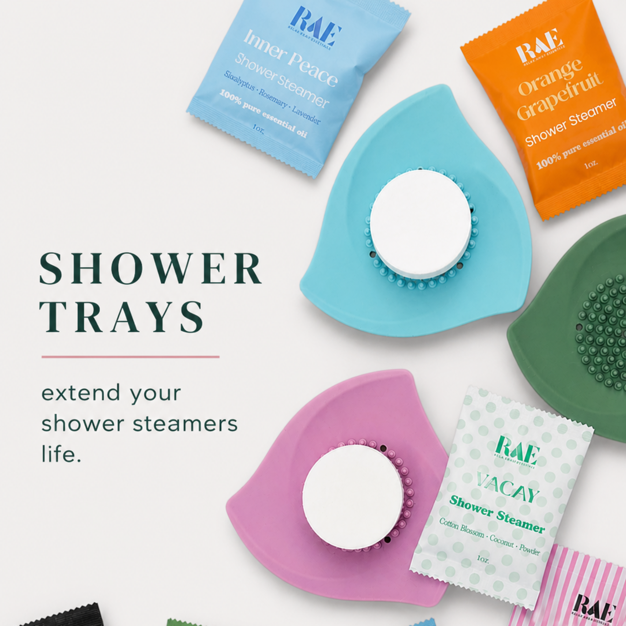 Silicone shower steamer trays in blue, pink, and green, each with raised stud pattern