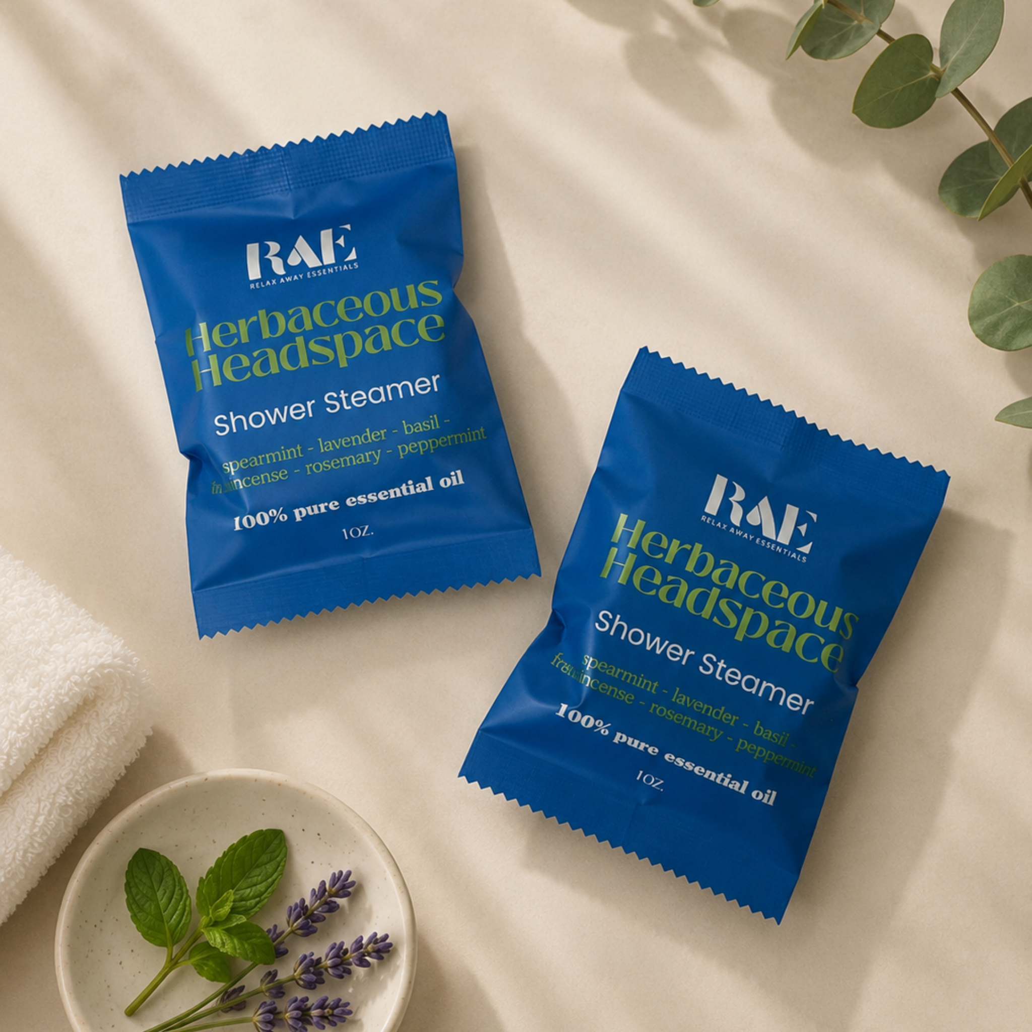 Two RAE shower steamer pouches on a neutral surface, blue and teal packaging