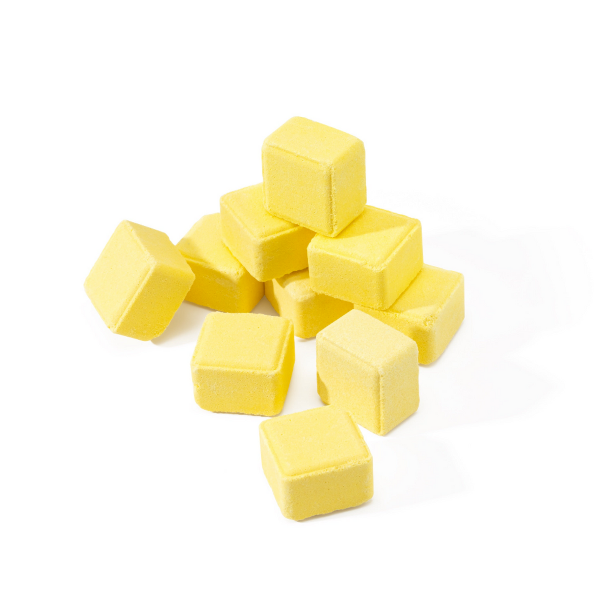 A pile of small, bright yellow cube-shaped bath salts on a clean white background.