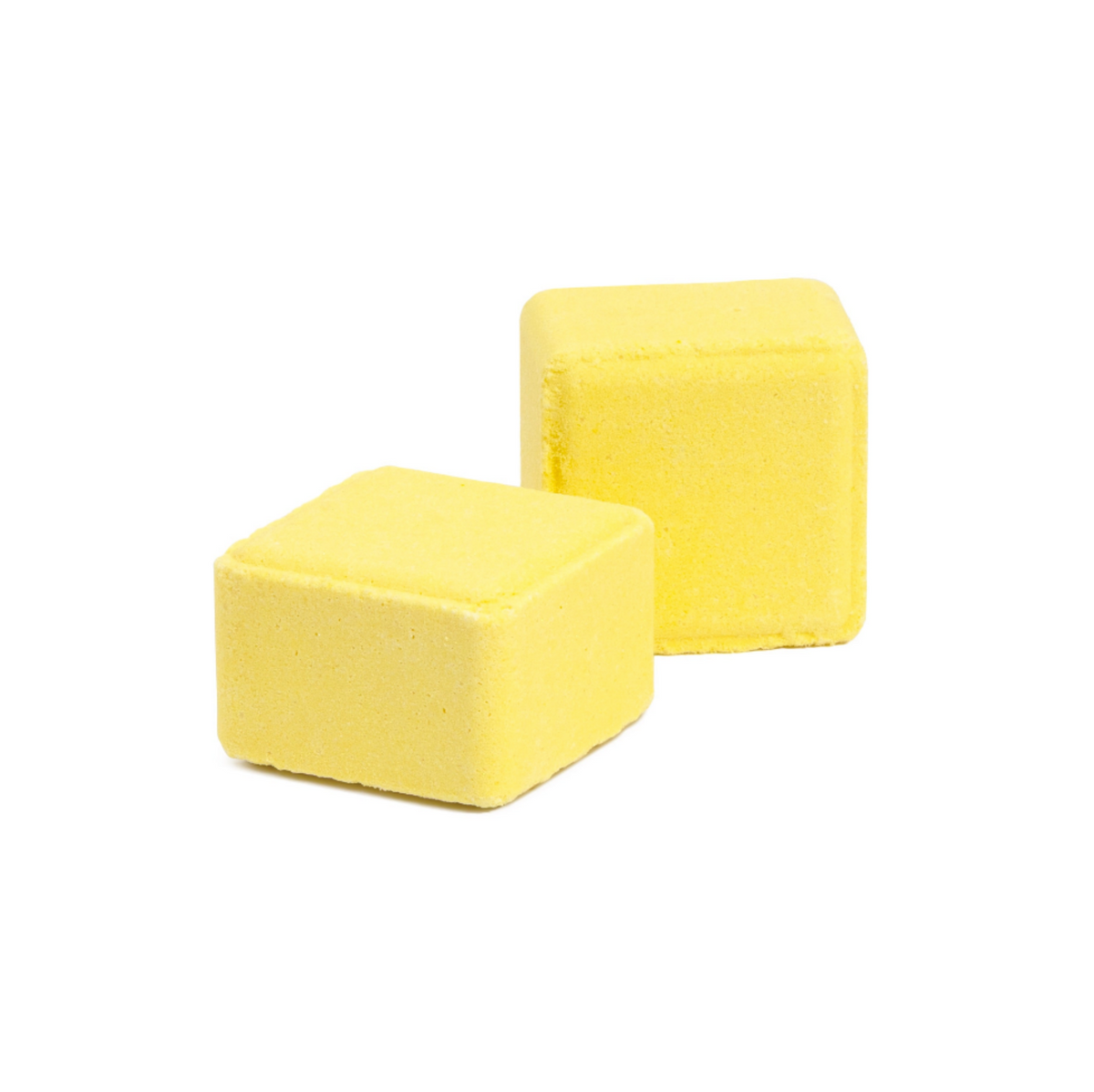 Two small yellow cube-shaped bath bombs on a plain white background.